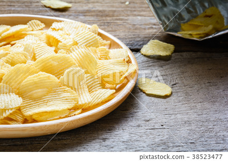 Snacks in a wooden dish on a table Snacks in a wooden dish on a table 38523477