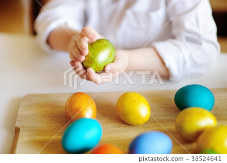 toddler child hunting for easter egg on Easter day 38524641