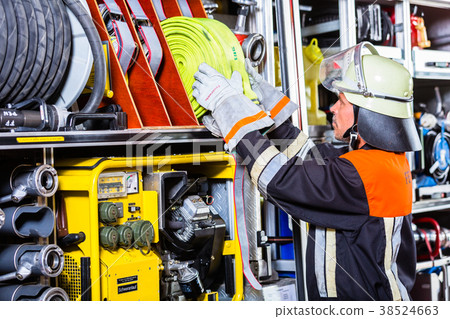 Fire fighters loading hoses into operations Fire fighters loading hoses into operations 38524663
