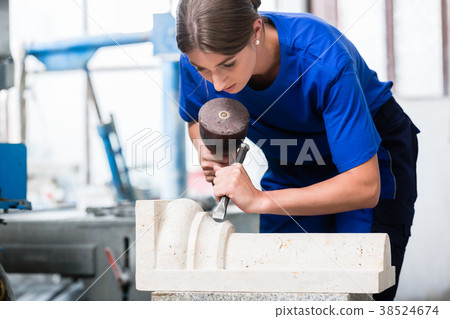 woman Stonemason carving pillar out of stone in woman Stonemason carving pillar out of stone in 38524674