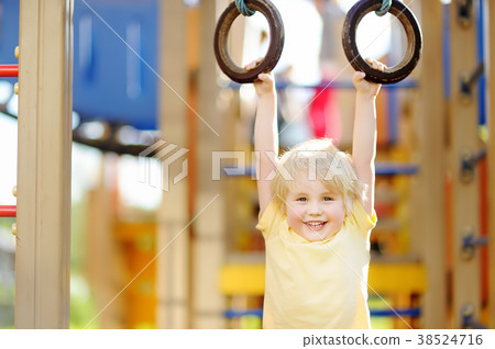 Little boy having fun on outdoor playground 38524716