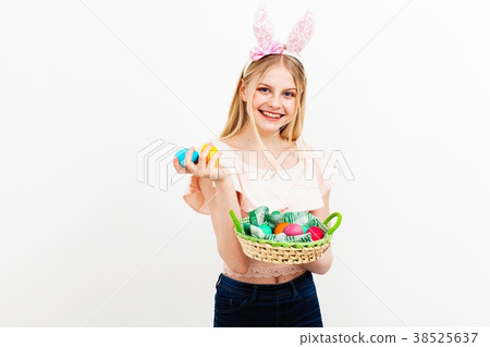 Teenage girl holding Easter eggs Teenage girl holding Easter eggs 38525637