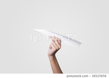 Hand holding paper plane isolated on gray Hand holding paper plane isolated on gray 38525656