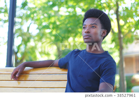 real people young man relaxing on bench park summer portrait spring day real people young man relaxing on bench park summer portrait spring day 38527961
