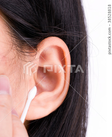 Woman is cleaning her ears with white cotton bud Woman is cleaning her ears with white cotton bud 38528818