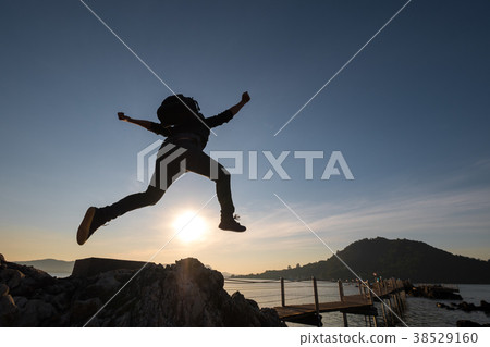 Freedom of life, Man jumping on rock Freedom of life, Man jumping on rock 38529160