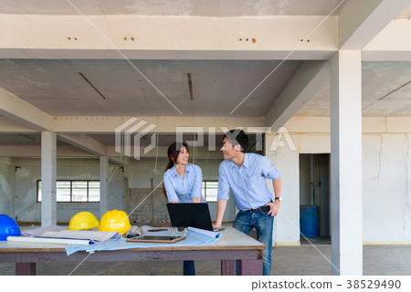 Couple asian engineers looking their project details at laptop i 38529490