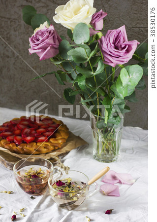 Dining table with flowers, herbal tea and pie 38530176