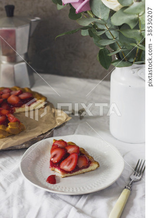 Dining table with flowers, coffee maker and pie 38530207