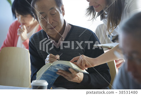 Senior attending English conversation class Senior attending English conversation class 38531480