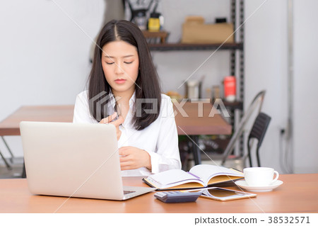 Beautiful asian young woman working on laptop Beautiful asian young woman working on laptop 38532571
