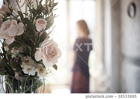 rose decoration home and blur woman standing window 38533895