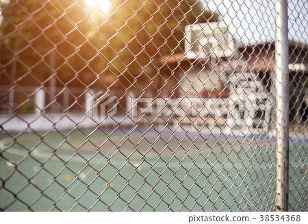 iron net fence fron of basketball court 38534368