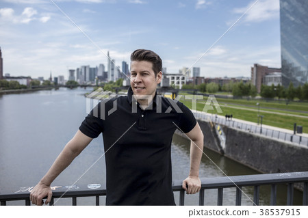 Man on City Bridge and Frankfurt Skyline Behind Man on City Bridge and Frankfurt Skyline Behind 38537915