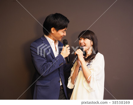 A couple staring and singing karaoke 38538169