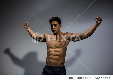 Flexing Pectorals and Biceps Angled View 38538351