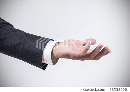Man in suit shows outstretched hand with open palm Man in suit shows outstretched hand with open palm 38538966
