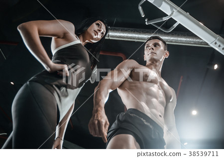 Model young man and woman working out in gym 38539711