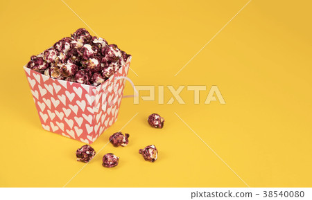 Pink popcorn with berry taste in paper cup on Pink popcorn with berry taste in paper cup on 38540080