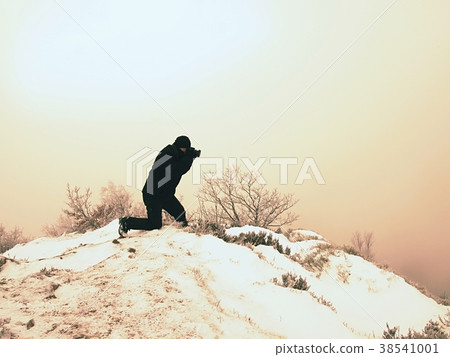 Professional photographer works in snow 38541001