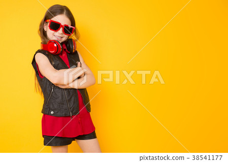 Little girl in headphones Little girl in headphones 38541177
