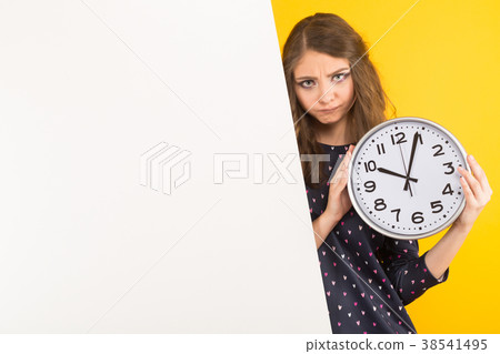 Brunette woman with clocks and blank banner Brunette woman with clocks and blank banner 38541495