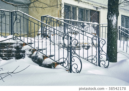 Staircase covered with snow after a great snow 38542178