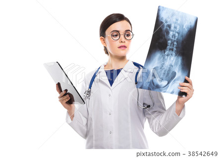 Young woman doctor with stethoscope looking at x 38542649