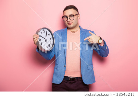 Handsome man in bright jacket with clocks 38543215