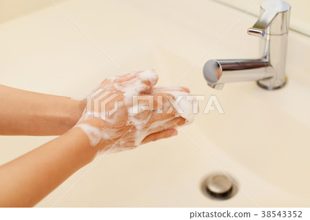 A woman washing her hands 38543352