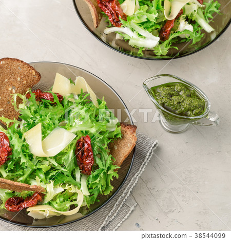 Frisee lettuce salad with sun dried tomatoes 38544099