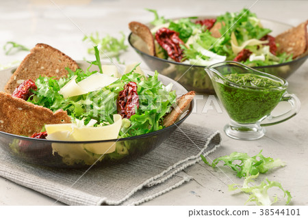 Frisee lettuce salad with sun dried tomatoes 38544101