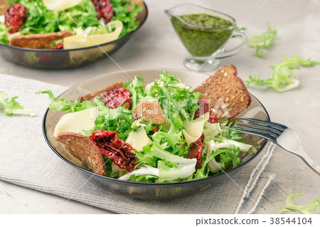 Frisee lettuce salad with sun dried tomatoes Frisee lettuce salad with sun dried tomatoes 38544104