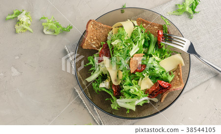 Frisee lettuce salad with sun dried tomatoes 38544105