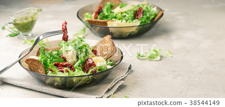 Frisee lettuce salad with sun dried tomatoes Frisee lettuce salad with sun dried tomatoes 38544149
