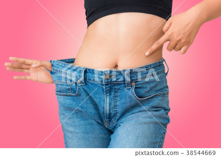 Young woman showing successful weight loss Young woman showing successful weight loss 38544669