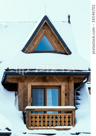 view of the window of a wooden house covered with snow view of the window of a wooden house covered with snow 38546702