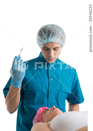 Plastic surgeon making injection to a woman Plastic surgeon making injection to a woman 38548255
