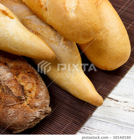 Freshly baked French baguettes on white table 38548580