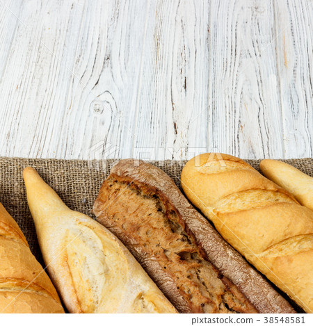 Homemade baguettes on wooden table. close up Homemade baguettes on wooden table. close up 38548581