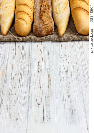 Assortment of fresh French baguettes on a table Assortment of fresh French baguettes on a table 38548604