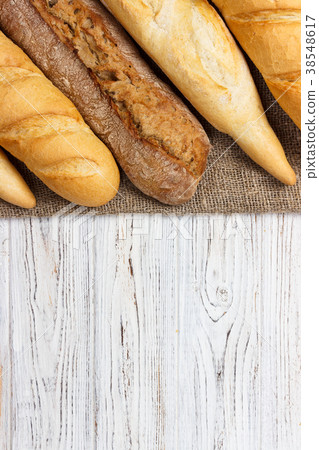 Loaf of bread on a white rustic table. baguette 38548617
