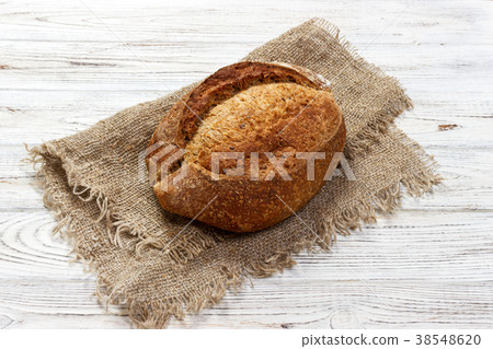 loaf of bread on wooden background, food closeup loaf of bread on wooden background, food closeup 38548620