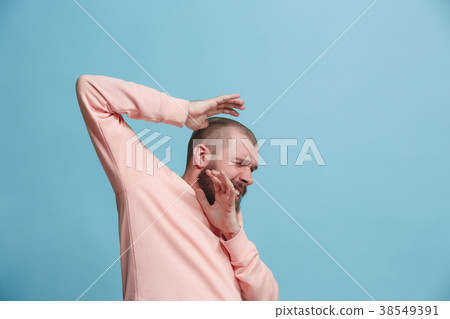 Portrait of the scared man on blue 38549391