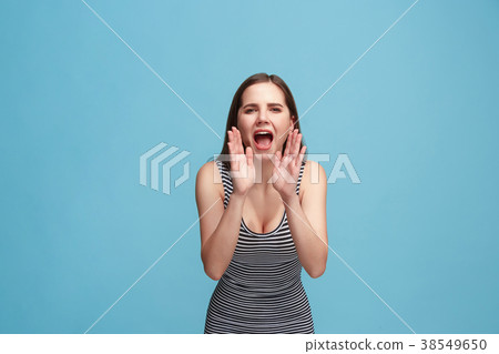 Isolated on blue young casual woman shouting at Isolated on blue young casual woman shouting at 38549650