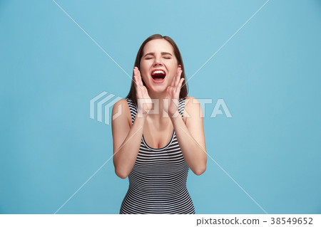 Isolated on blue young casual woman shouting at Isolated on blue young casual woman shouting at 38549652