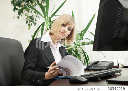 Woman working with computer in the office Woman working with computer in the office 38549919