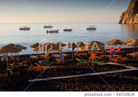 Beach in Kamari,, Santorini island, Greece. Beach in Kamari,, Santorini island, Greece. 38550626