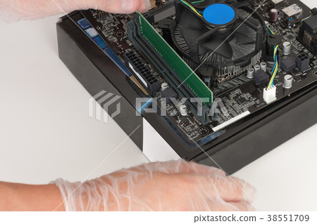 Close up of man hands installing Ram memory  38551709