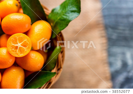 Kumquat or cumquat on wooden table Kumquat or cumquat on wooden table 38552077